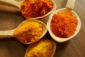 spoons filled with turmeric powder